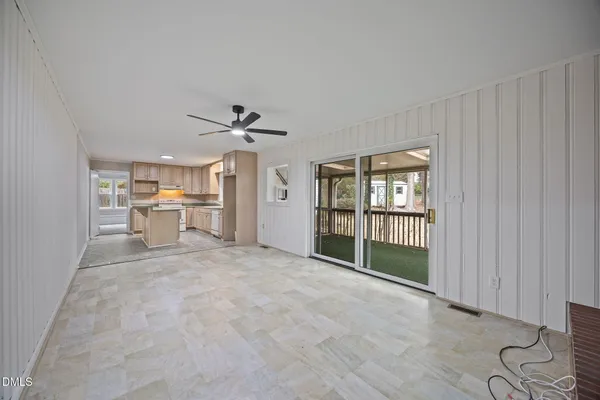 a view of a livingroom with a ceiling fan and window