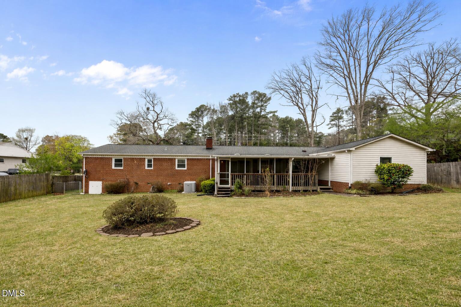 637 Buck Jones Road Raleigh, NC 27606 - Photo 28 of 32 a view of a house with a yard and trees