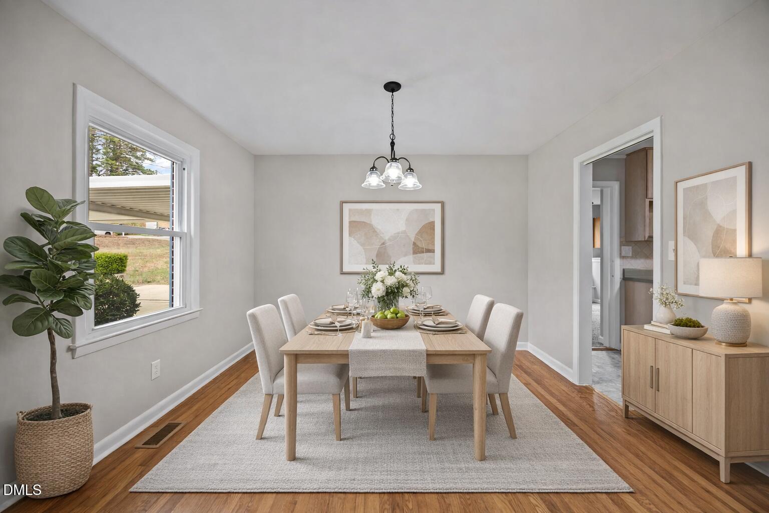 637 Buck Jones Road Raleigh, NC 27606 - Photo 6 of 32 a dining room with furniture potted plants and wooden floor