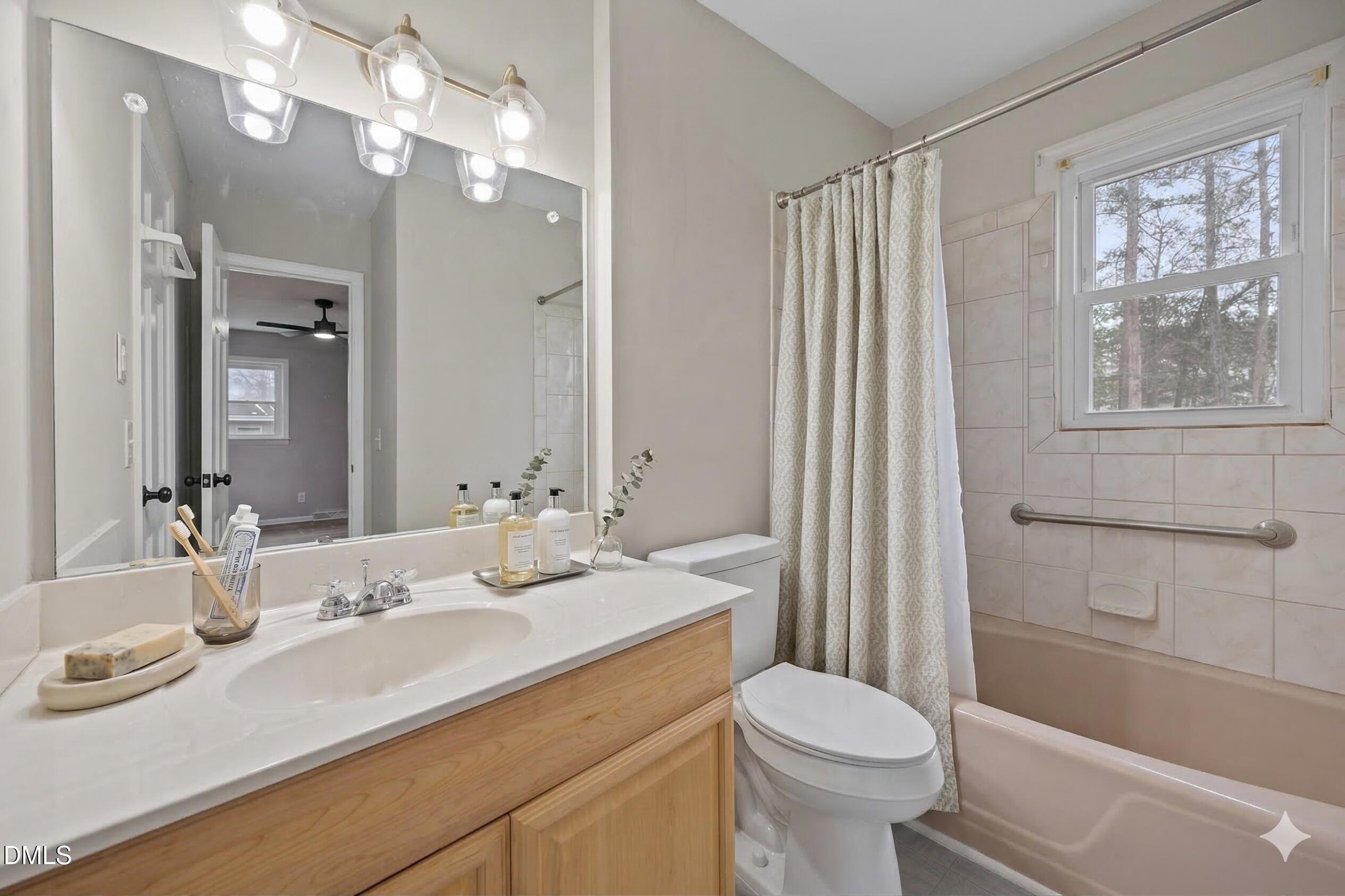 637 Buck Jones Road Raleigh, NC 27606 - Photo 9 of 32 a bathroom with a sink a toilet and shower