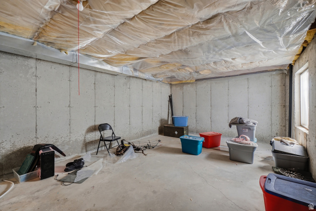 2135 East White Pine Road Eagle Mountain, UT 84005 - Photo 20 of 23 Unfinished basement featuring concrete walls and flooring, exposed ceiling insulation, and a single window providing natural light