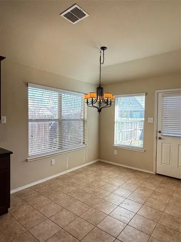 a view of an empty room with windows