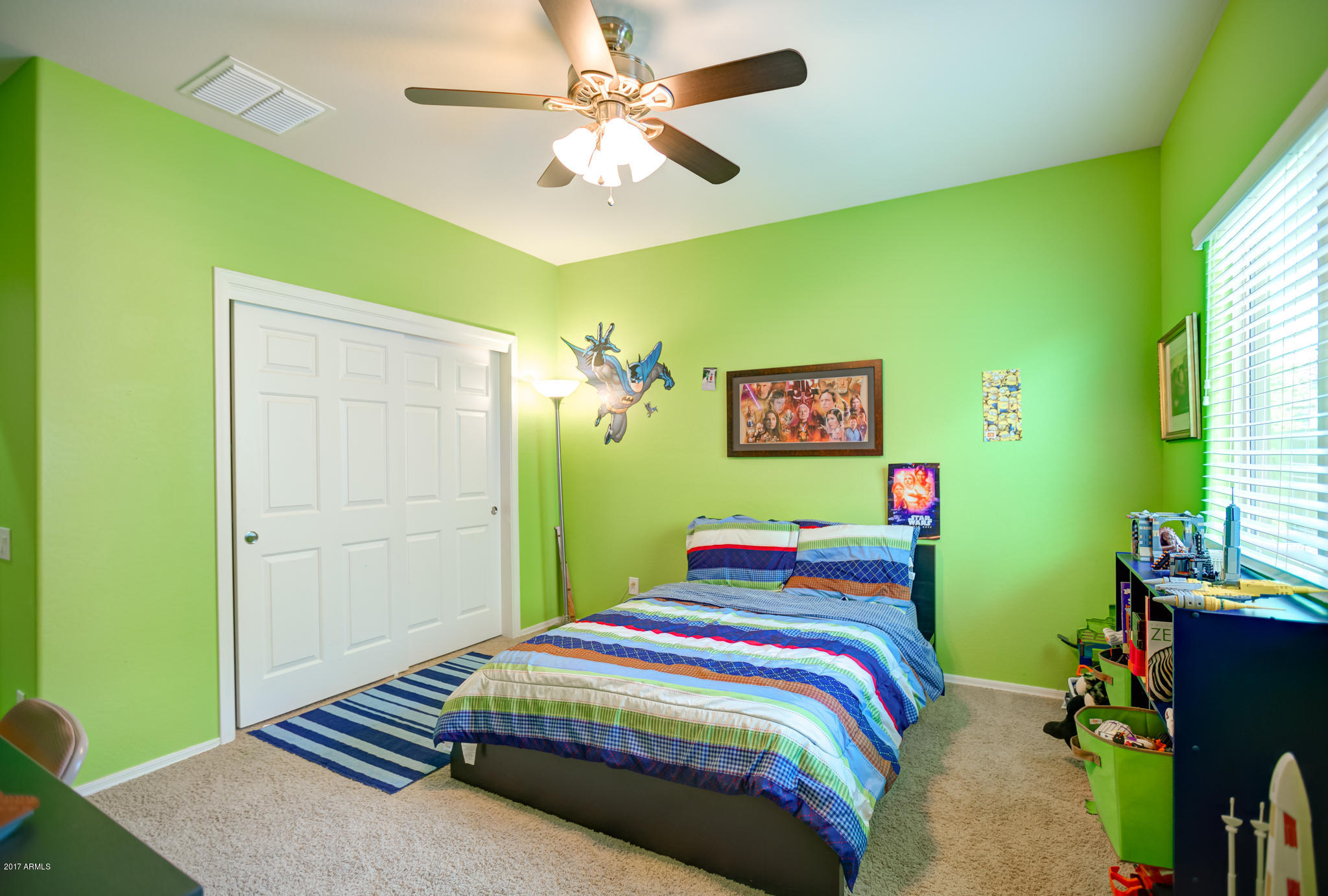 3515 East Ivanhoe Street Gilbert, AZ 85295 - Photo 27 of 49 a bedroom with a bed and a chandelier