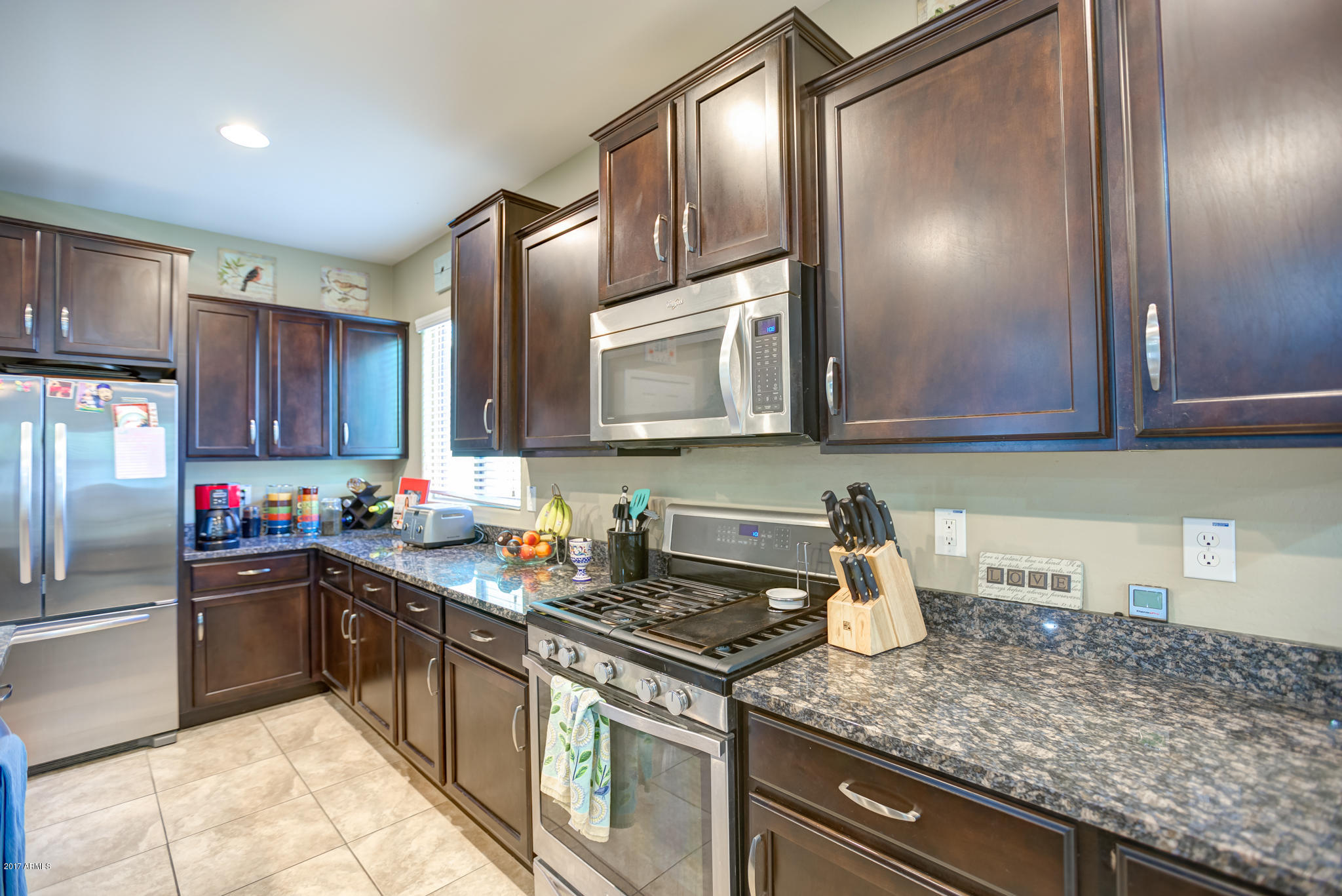 3515 East Ivanhoe Street Gilbert, AZ 85295 - Photo 4 of 49 a kitchen with stainless steel appliances granite countertop a sink stove and cabinets