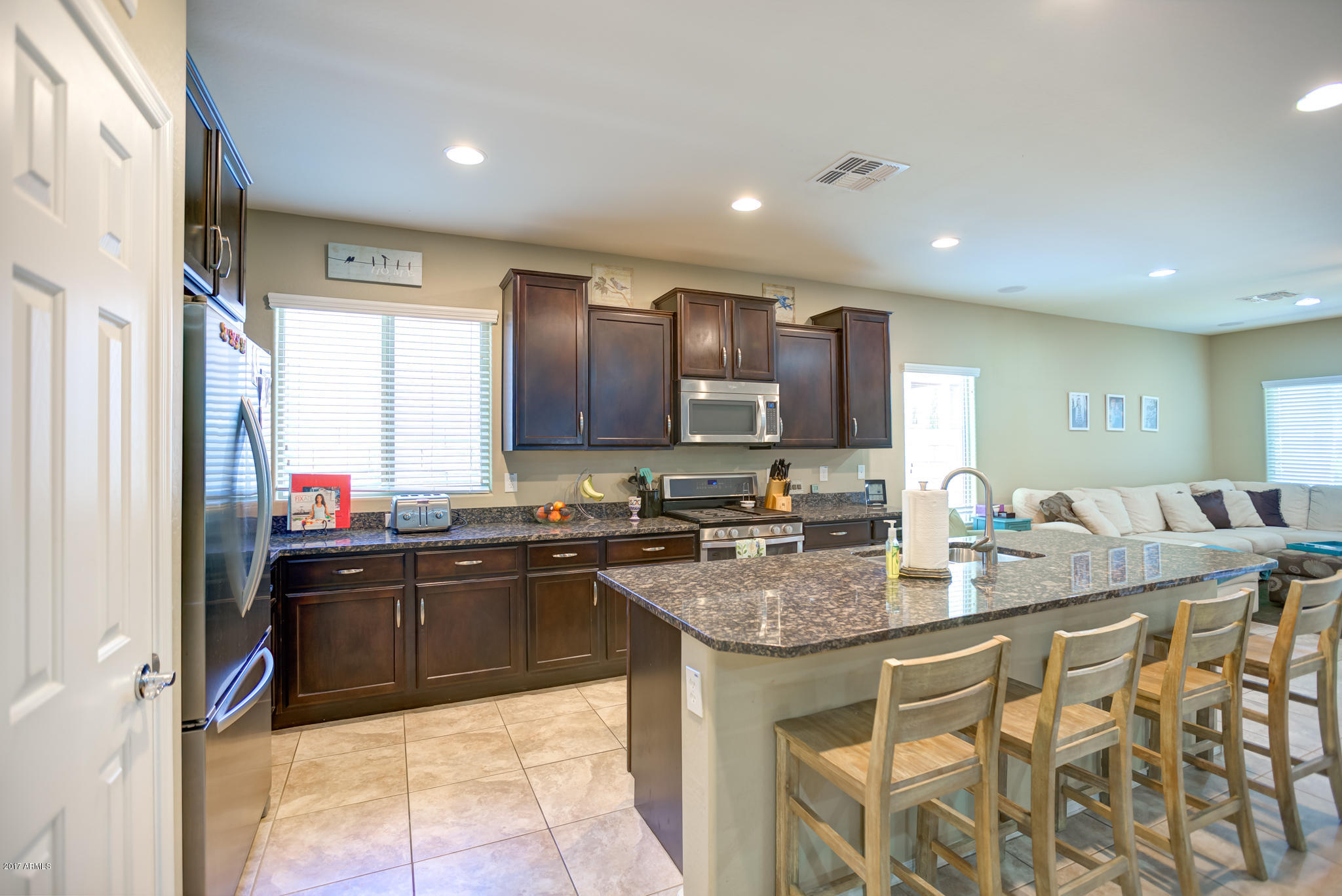 3515 East Ivanhoe Street Gilbert, AZ 85295 - Photo 6 of 49 a kitchen with kitchen island granite countertop a sink counter top space appliances and cabinets