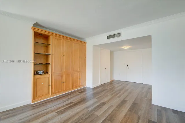 a room with a bed and cabinets