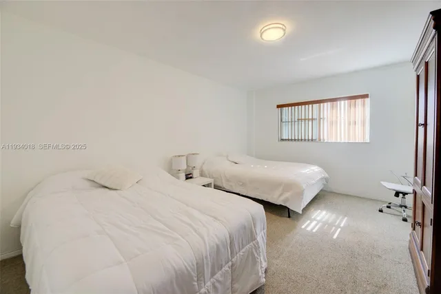 a bedroom with two beds and painted walls