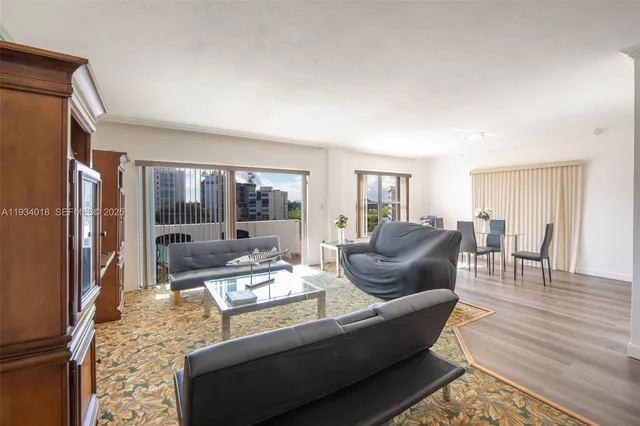 a living room with furniture a large window and a table