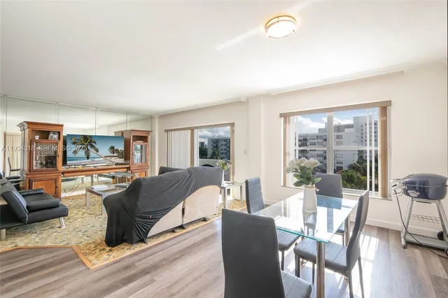 a view of a dining room with furniture and wooden floor