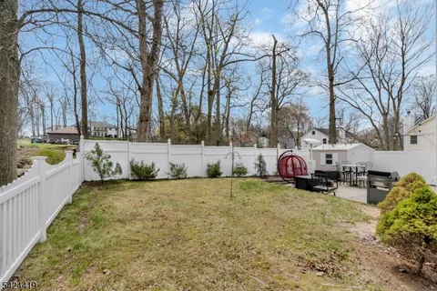 a backyard of a house with fire pit and couches