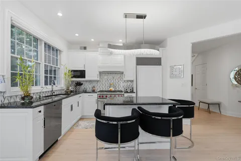 a kitchen with a sink and chairs