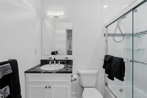 a bathroom with a sink toilet and shower