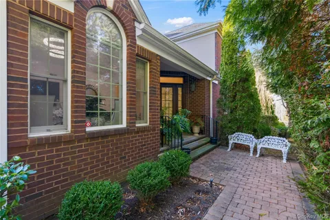 a view of a chair and table in the backyard