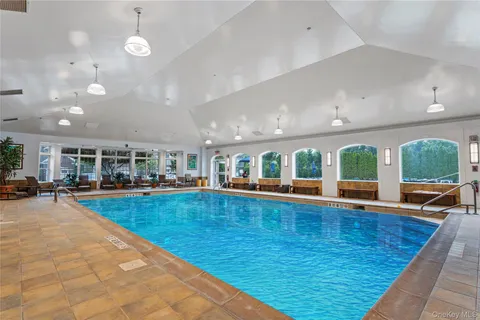 an outdoor space with swimming pool and furniture