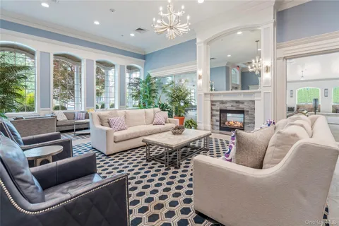 a living room with furniture fireplace and a table
