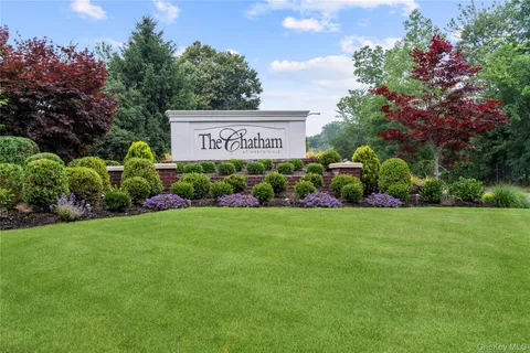 a view of a sign in front of flowers