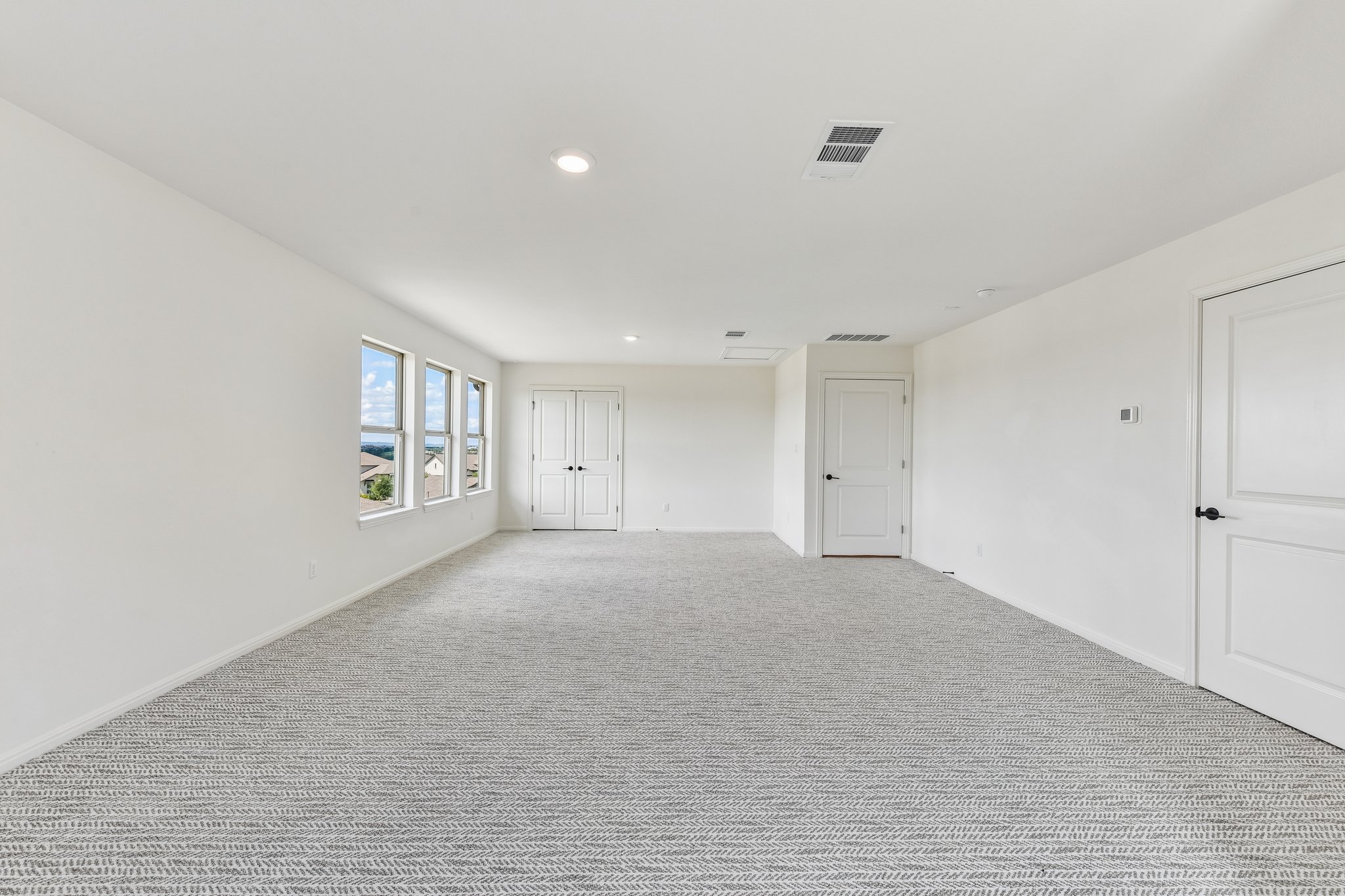 19113 Freeman Circle Austin, TX 78738 - Photo 22 of 37 Ample windows illuminate this generous bonus room, offering flexible space for any lifestyle.