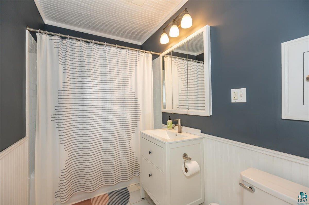 5401 Otsego Street Duluth, MN 55804 - Photo 14 of 36 Bathroom featuring a white beadboard ceiling, dark gray walls, and white wainscoting