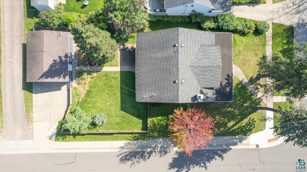 5401 Otsego Street Duluth, MN 55804 - Photo 31 of 36 Aerial property overview featuring a main residence with a shingle roof, a detached garage, a concrete driveway, established landscaping, and a corner lot