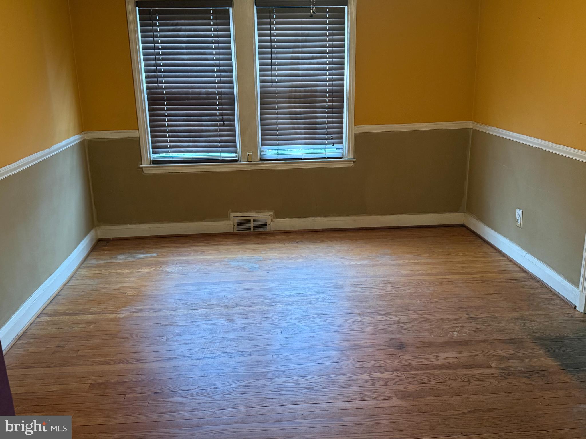1929 Edgewood Road Towson, MD 21286 - Photo 4 of 10 a view of an empty room with wooden floor and a window