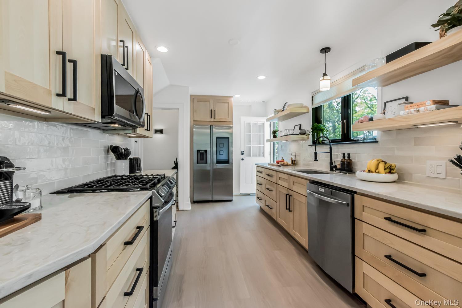 209 Storer Avenue New Rochelle, NY 10801 - Photo 11 of 39 a kitchen with stainless steel appliances granite countertop a sink stove and refrigerator