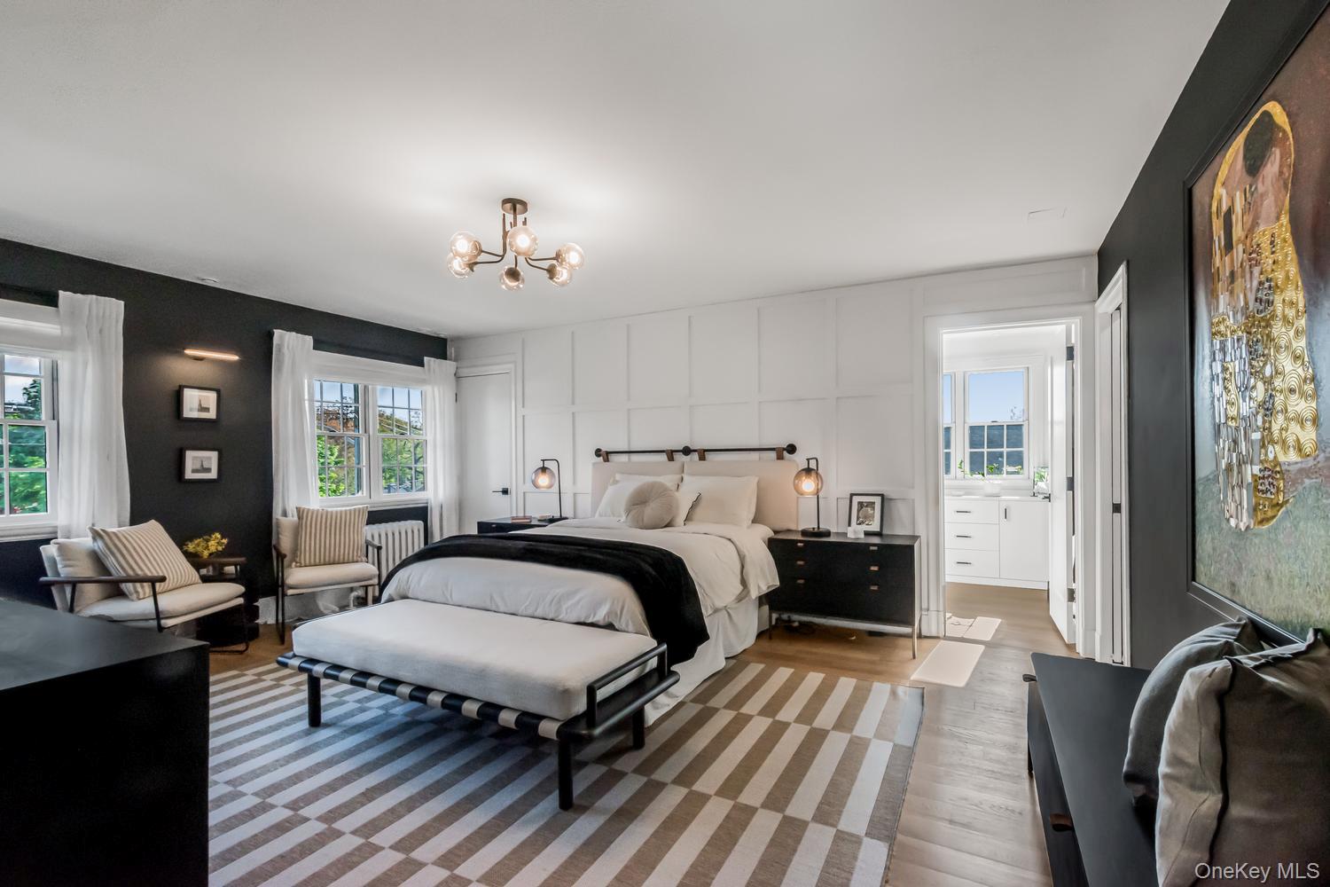 209 Storer Avenue New Rochelle, NY 10801 - Photo 14 of 39 a spacious bedroom with a bed a table and large windows