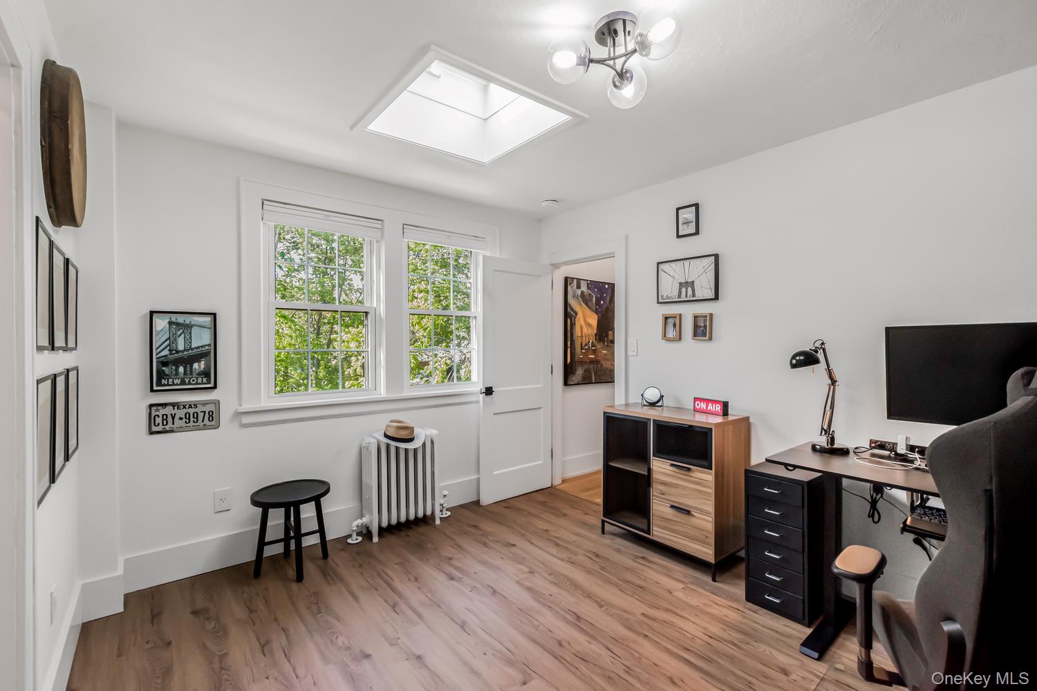 209 Storer Avenue New Rochelle, NY 10801 - Photo 21 of 39 a view of a workspace with furniture and a flat screen tv