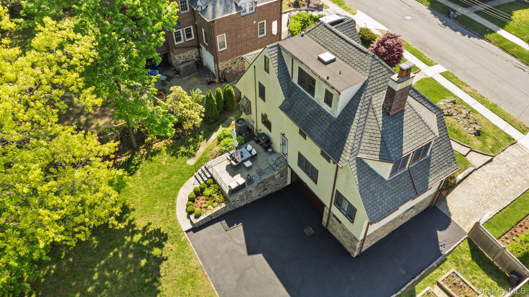 209 Storer Avenue New Rochelle, NY 10801 - Photo 23 of 39 an aerial view of a house with a garden
