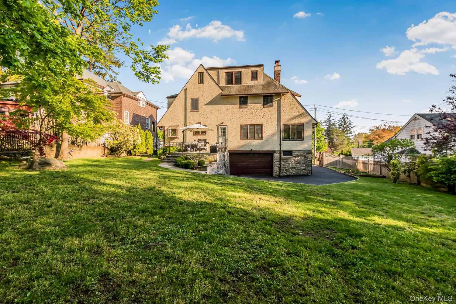 209 Storer Avenue New Rochelle, NY 10801 - Photo 27 of 39 a front view of a house with a garden