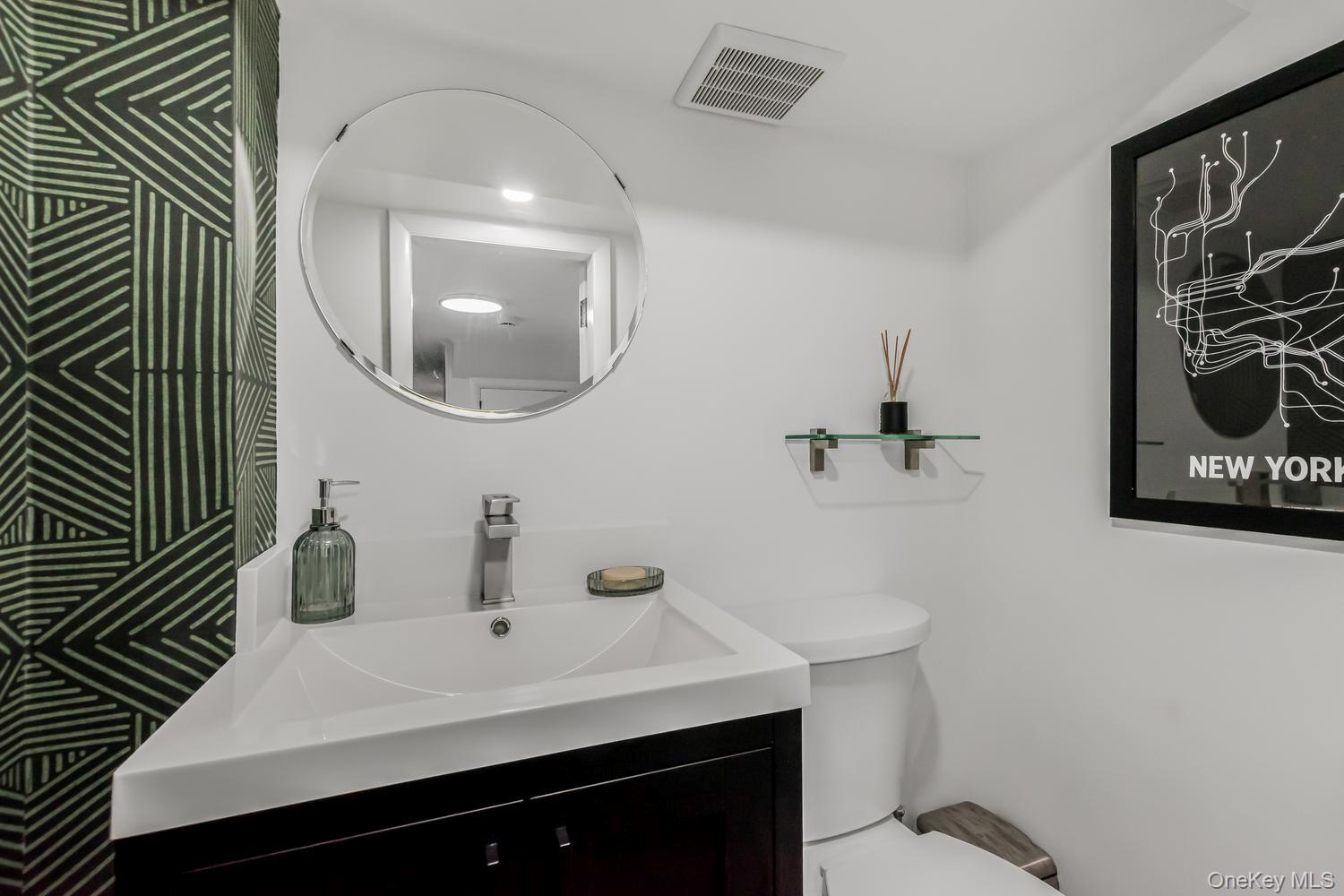 209 Storer Avenue New Rochelle, NY 10801 - Photo 30 of 39 a bathroom with a sink and mirror