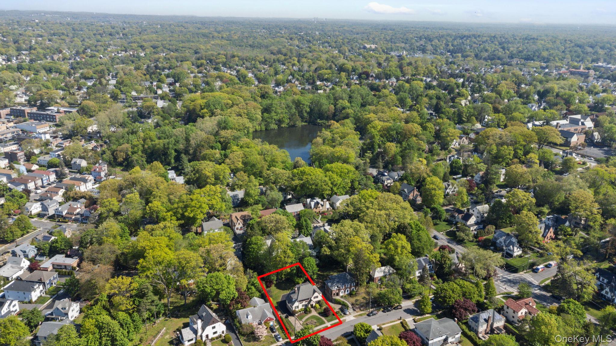 209 Storer Avenue New Rochelle, NY 10801 - Photo 32 of 39 an aerial view of a houses with a lush green hillside