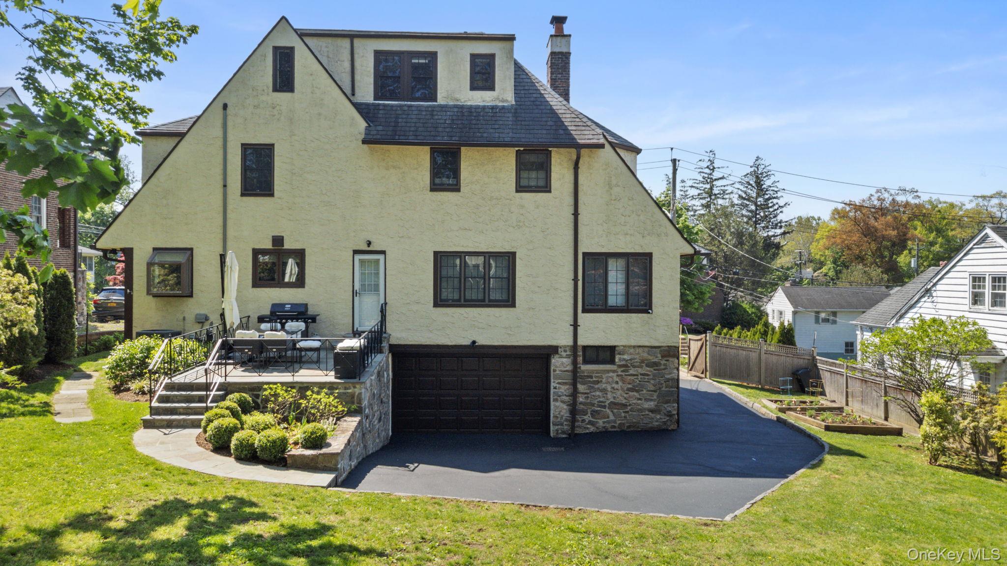 209 Storer Avenue New Rochelle, NY 10801 - Photo 33 of 39 a front view of a house with a yard and outdoor seating