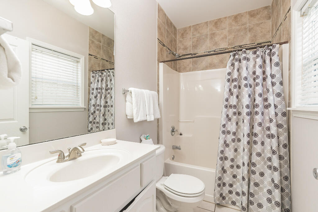 159 Gulfside Way Miramar Beach, FL 32550 - Photo 14 of 17 a bathroom with a sink a toilet a window and a mirror