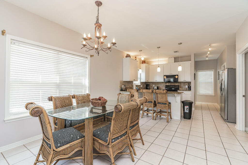 159 Gulfside Way Miramar Beach, FL 32550 - Photo 5 of 17 a dining room filled with furniture and a chandelier