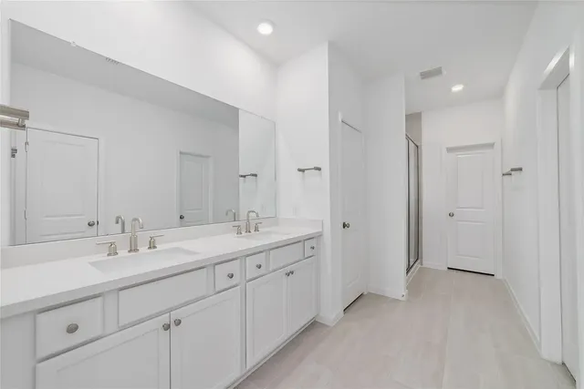 a spacious bathroom with a double vanity sink mirror and