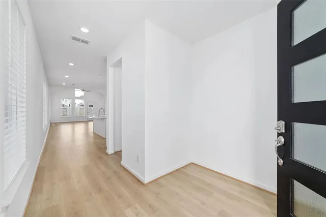 a view of a hallway with wooden floor