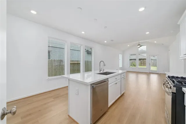 a kitchen with a sink stove and cabinets