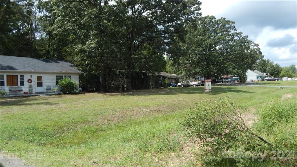 a house view with swimming pool in front of it