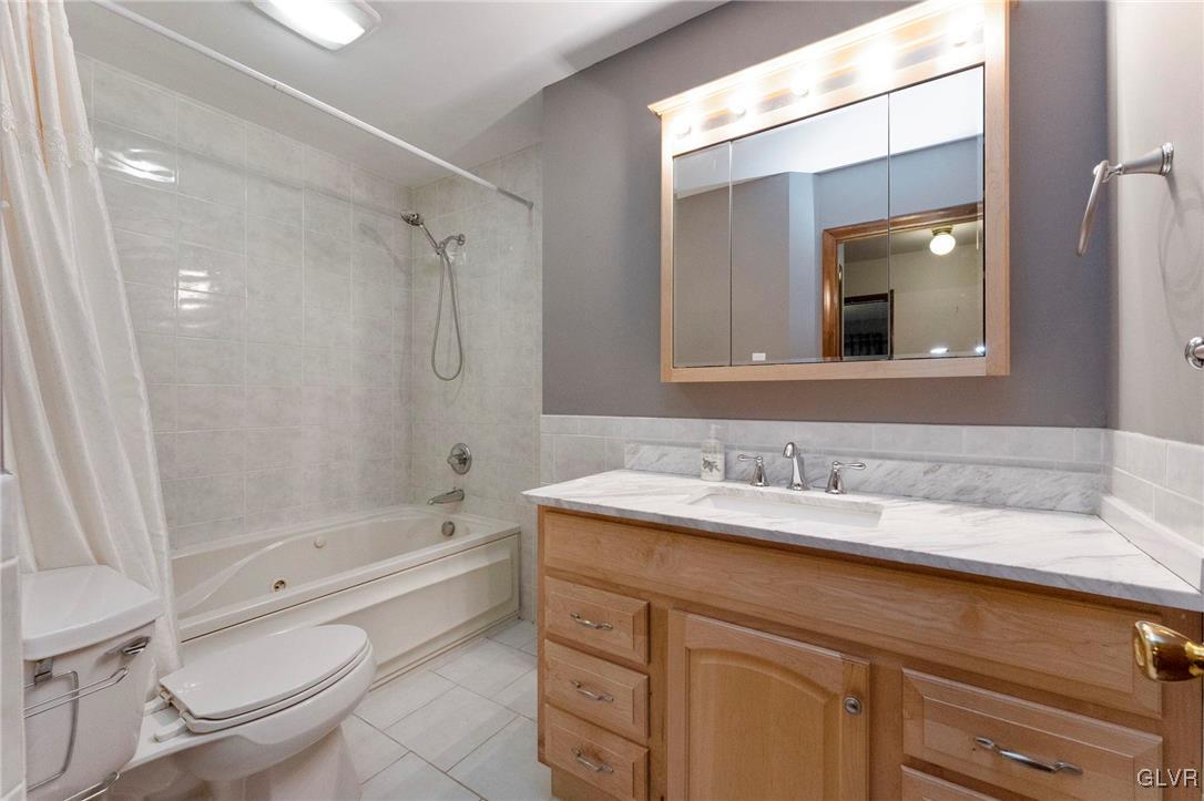7058 Limerick Square Bethlehem, PA 18017 - Photo 21 of 30 a bathroom with a granite countertop sink toilet and shower