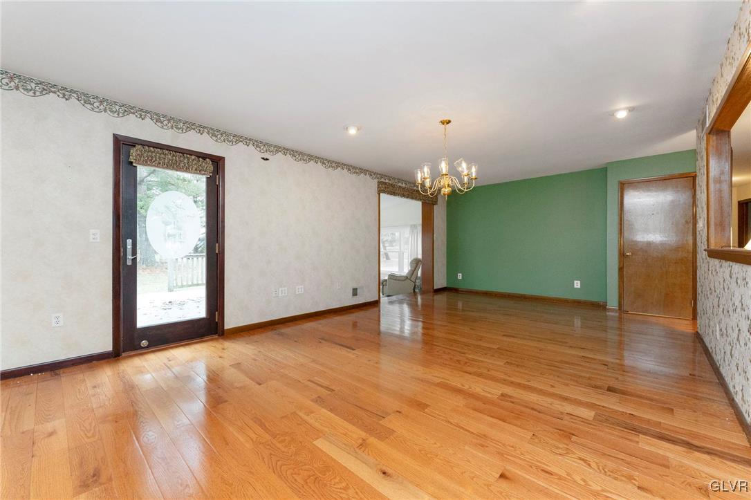 7058 Limerick Square Bethlehem, PA 18017 - Photo 8 of 30 a view of an empty room with window and wooden floor