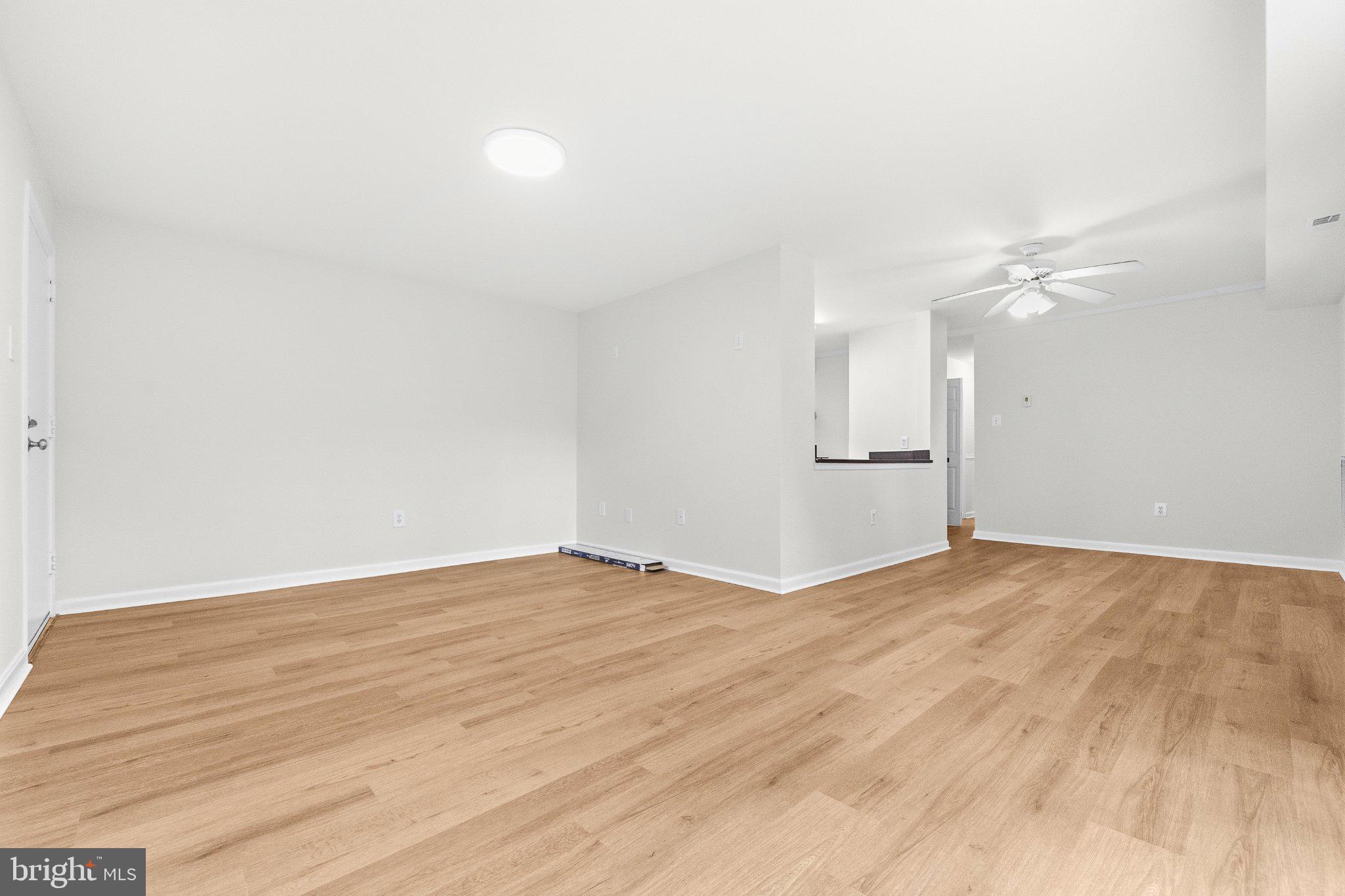 635 Waterloo Road, Unit 222 Warrenton, VA 20186 - Photo 8 of 28 a view of empty room with wooden floor and fan