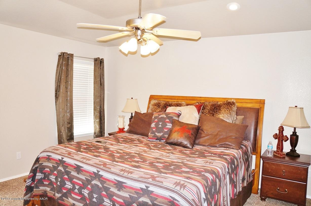 4910 Capulin Lane Amarillo, TX 79110 - Photo 13 of 17 a bedroom with a bed and ceiling fan