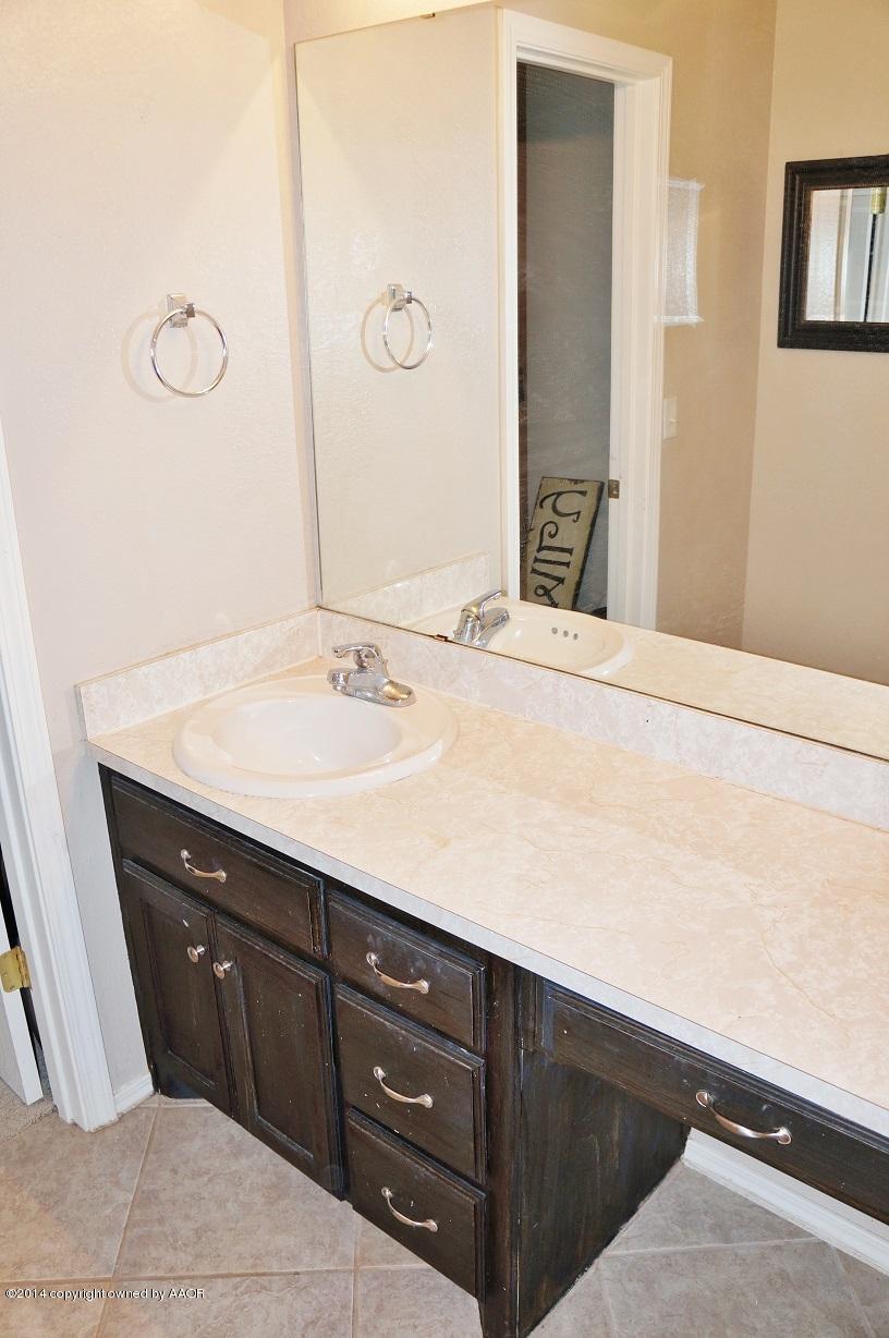 4910 Capulin Lane Amarillo, TX 79110 - Photo 15 of 17 a bathroom with a sink and a mirror