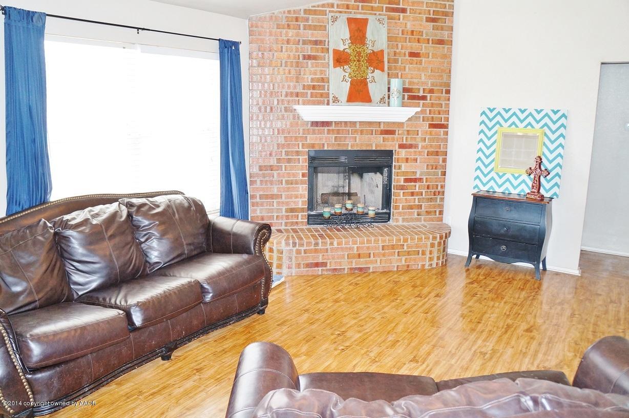 4910 Capulin Lane Amarillo, TX 79110 - Photo 3 of 17 a living room with furniture and a fireplace