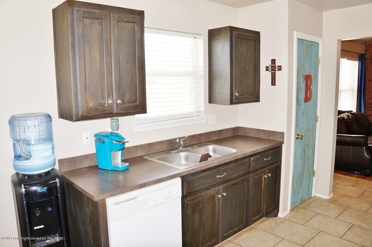 4910 Capulin Lane Amarillo, TX 79110 - Photo 5 of 17 a kitchen with a sink and cabinets