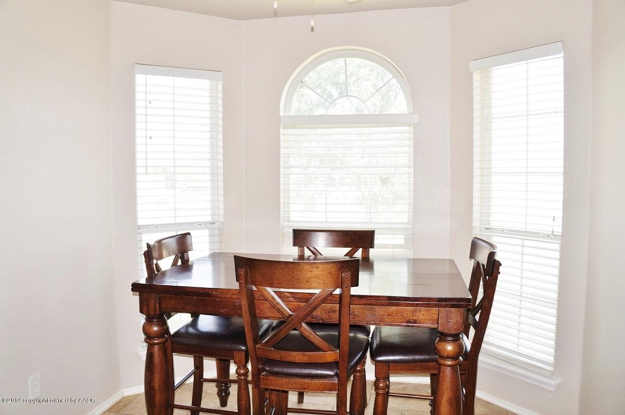 4910 Capulin Lane Amarillo, TX 79110 - Photo 7 of 17 a view of a dining room with furniture and a window