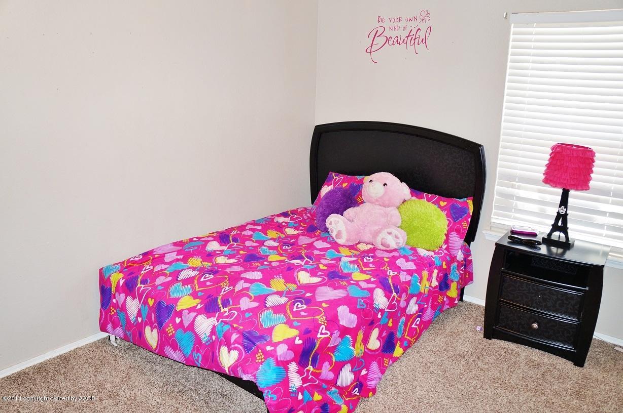 4910 Capulin Lane Amarillo, TX 79110 - Photo 8 of 17 a bedroom with a bed and a couch