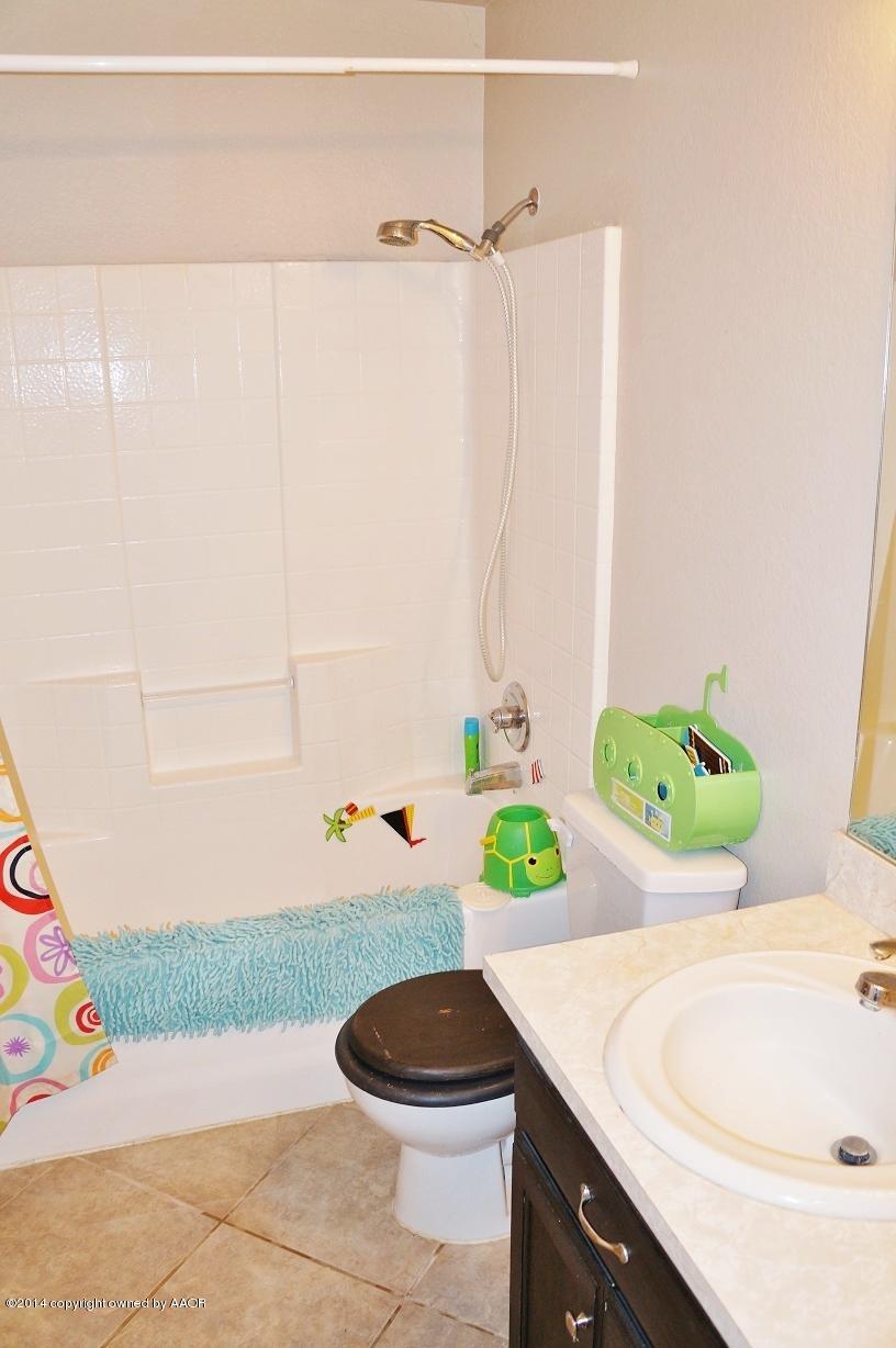 4910 Capulin Lane Amarillo, TX 79110 - Photo 10 of 17 a bathroom with a sink and a bathtub