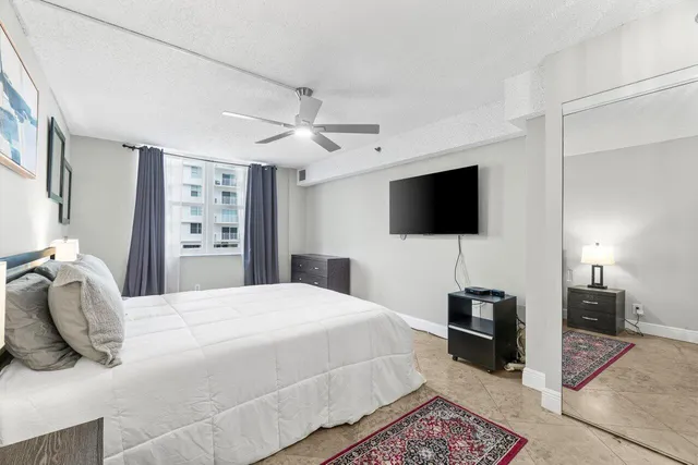 a bedroom with a bed and a flat screen tv