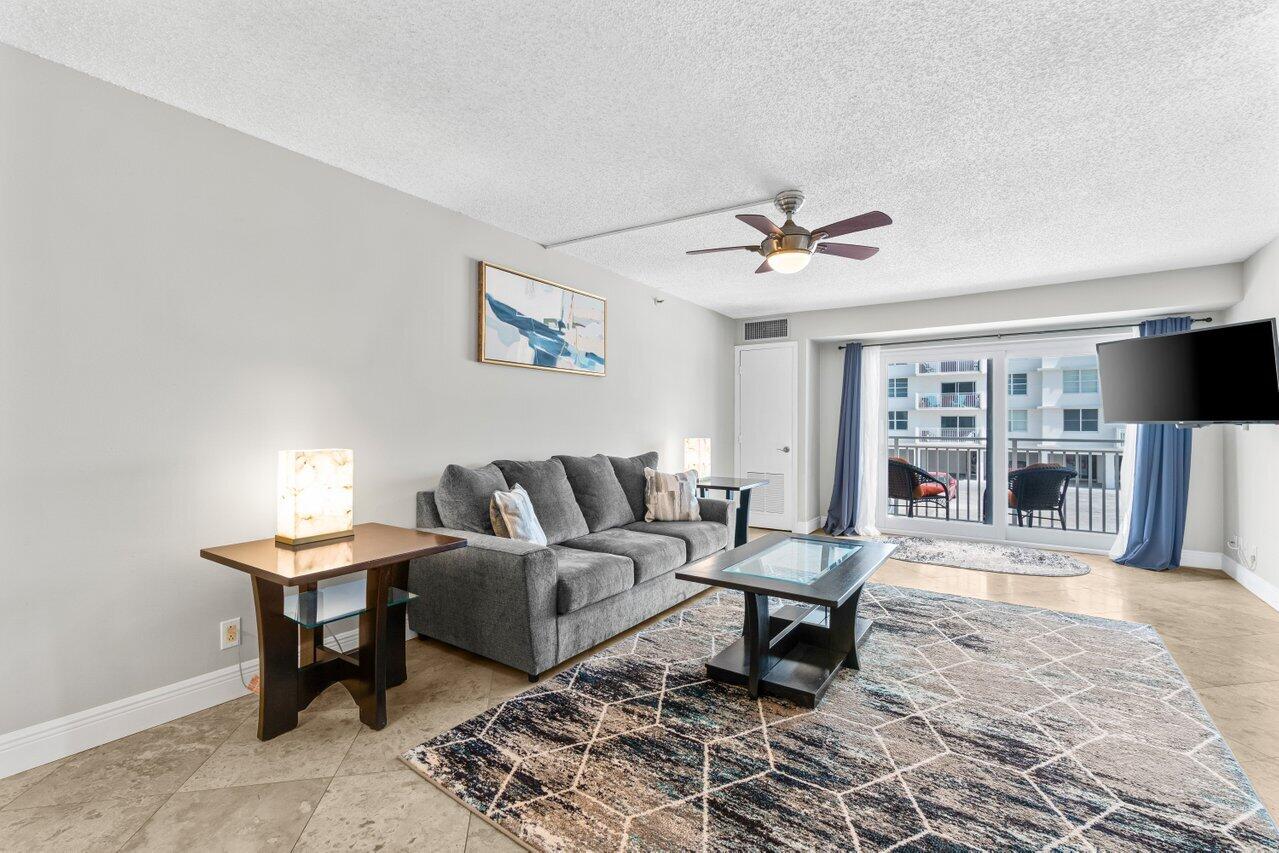 4511 South Ocean Boulevard, Unit 106 Highland Beach, FL 33487 - Photo 5 of 37 a living room with furniture and a fireplace